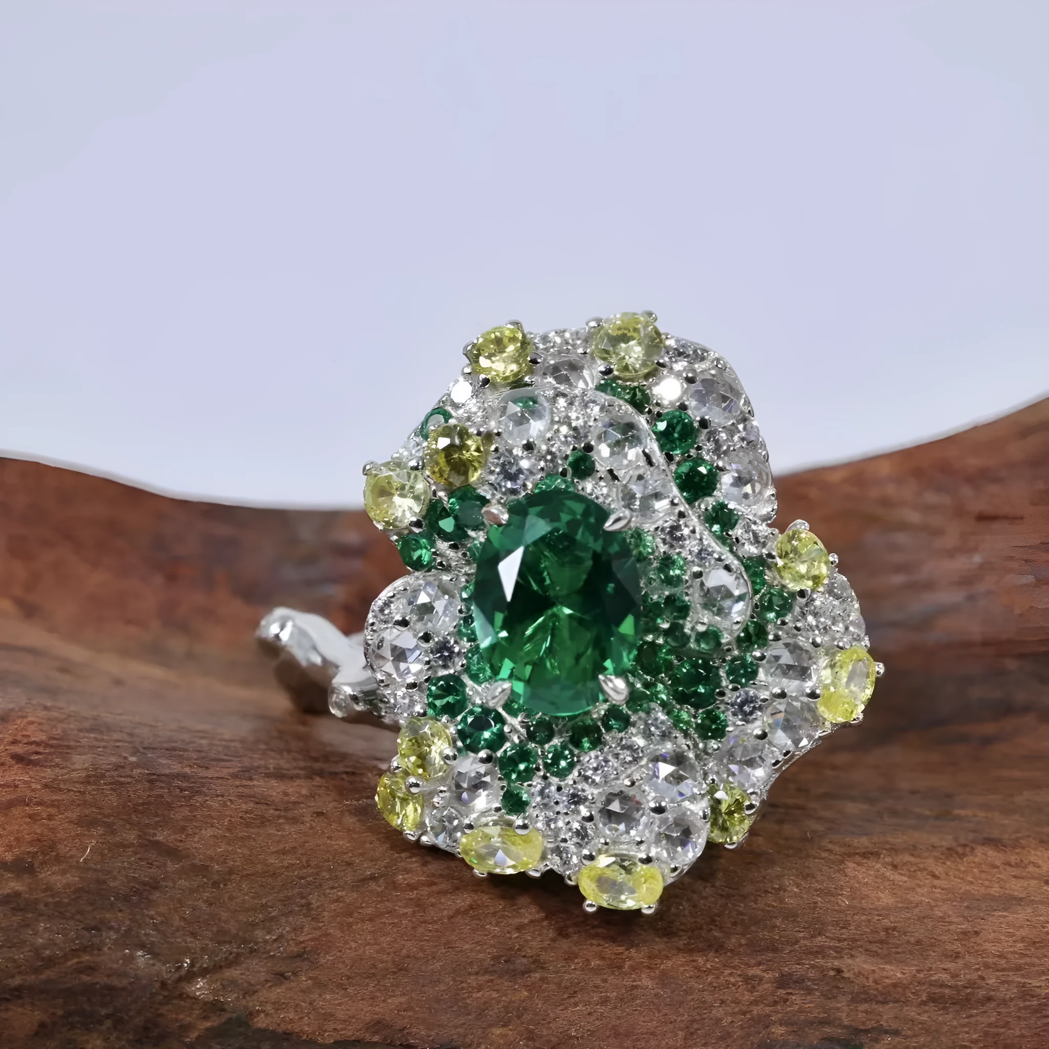 Secret Garden Series gradient emerald ring on a plain background showing the stone colour