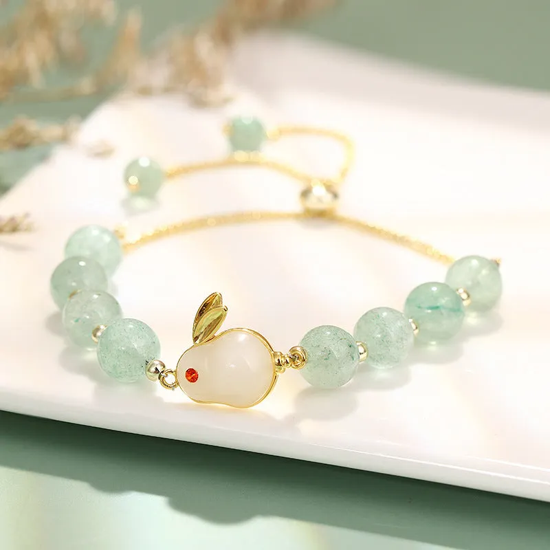 Women's rabbit design bracelet with green natural stones and copper gold accents