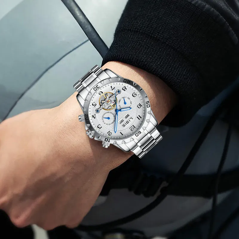 Men's silver automatic perpetual calendar watch with stainless steel strap on a wrist.
