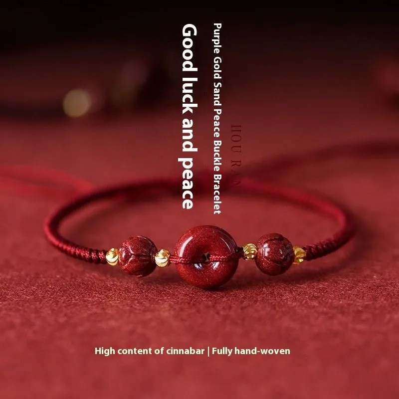 Traditional cinnabar bracelet with a heart-shaped peace buckle clasp on a red rope.