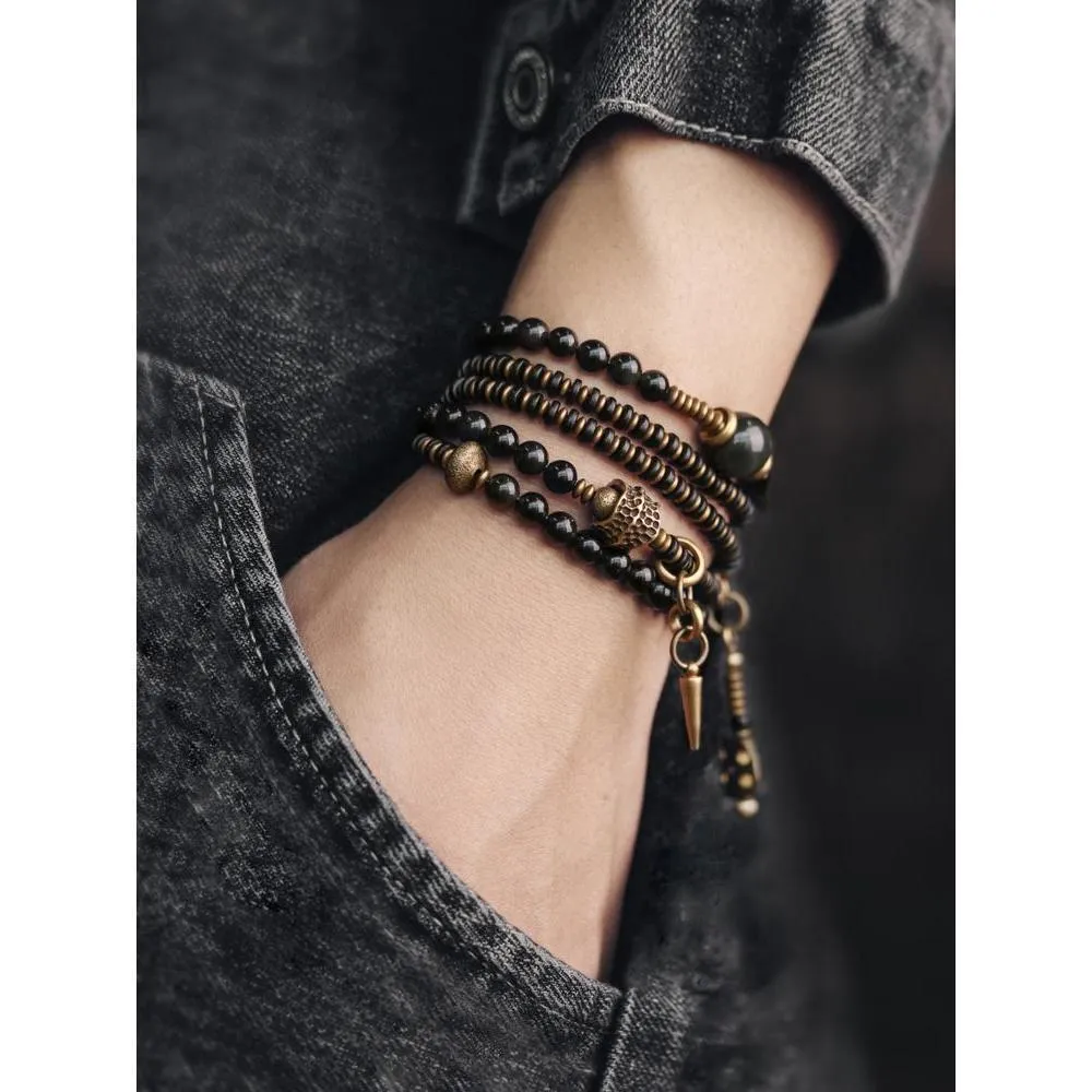 Black geometric patterned beaded bracelet with multi-layered natural materials design