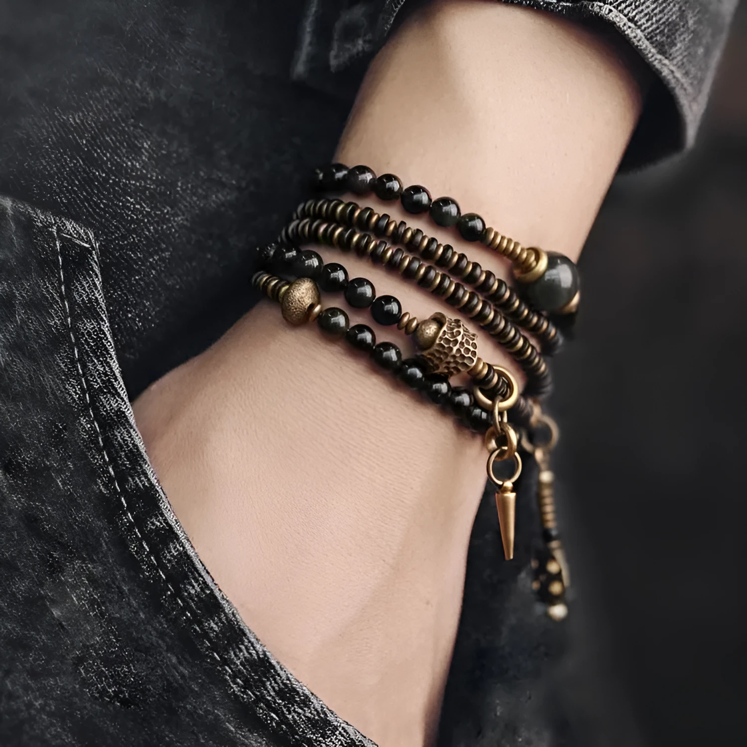 Black geometric patterned beaded bracelet with multi-layered natural materials design