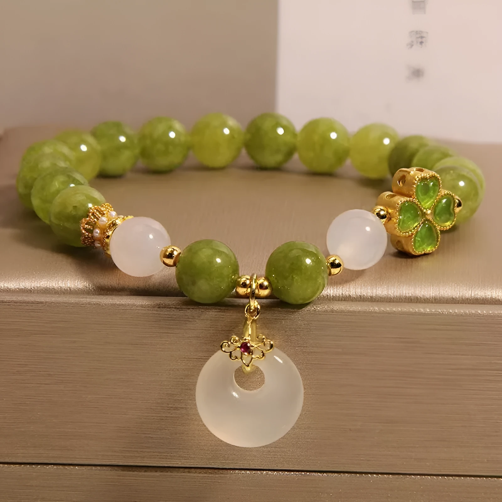 Women's green tourmaline four-leaf clover bracelet with silver electroplated finish and safety buckle clasp.