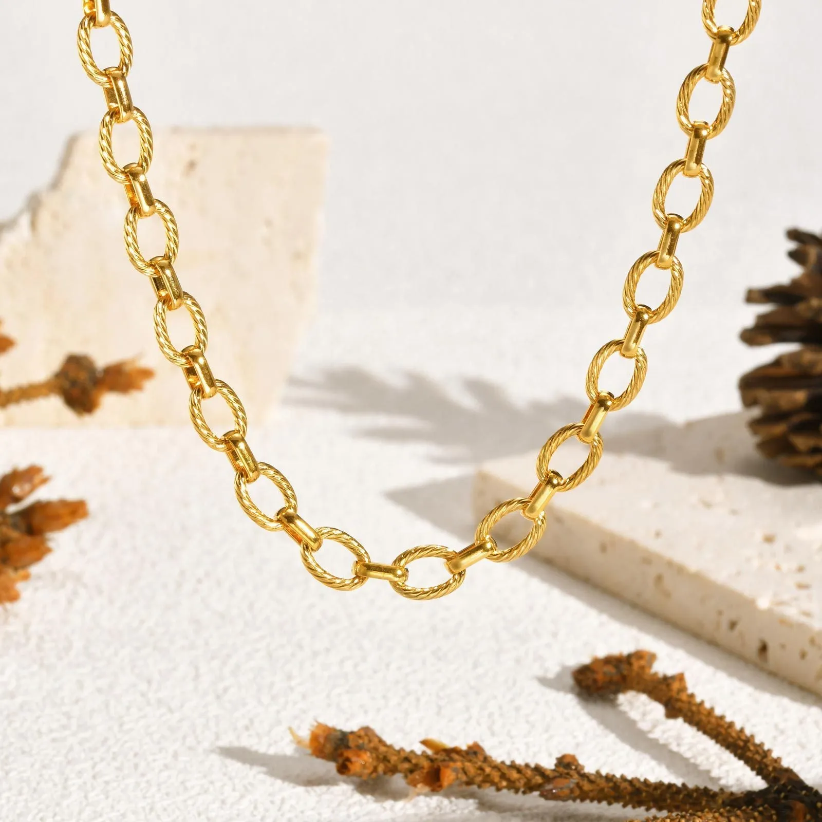 Women's stainless steel embossed geometric jewellery set in gold including necklace and bracelet
