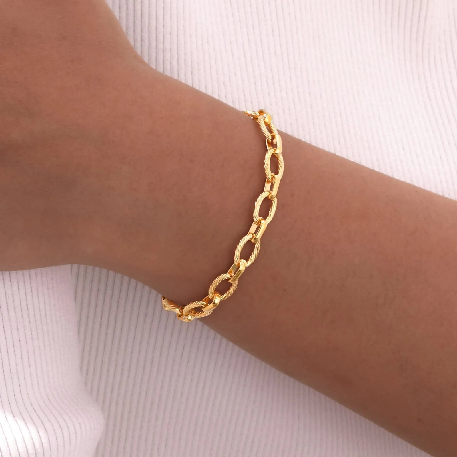 Women's stainless steel embossed geometric jewellery set in gold including necklace and bracelet