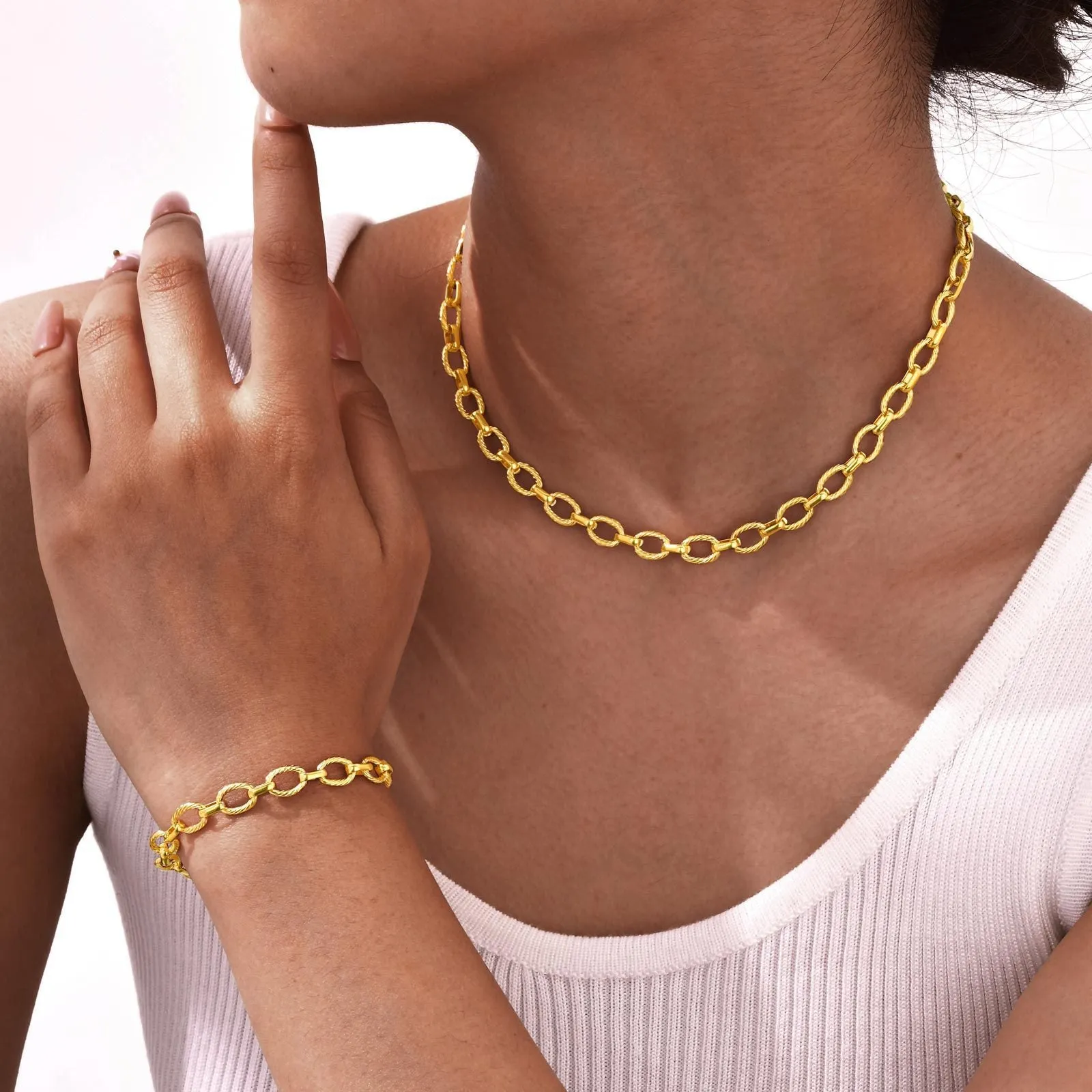 Women's stainless steel embossed geometric jewellery set in gold including necklace and bracelet