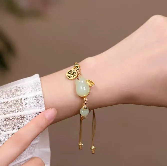 Yellow string bracelet with a geometric Hetian jade rabbit charm for women.