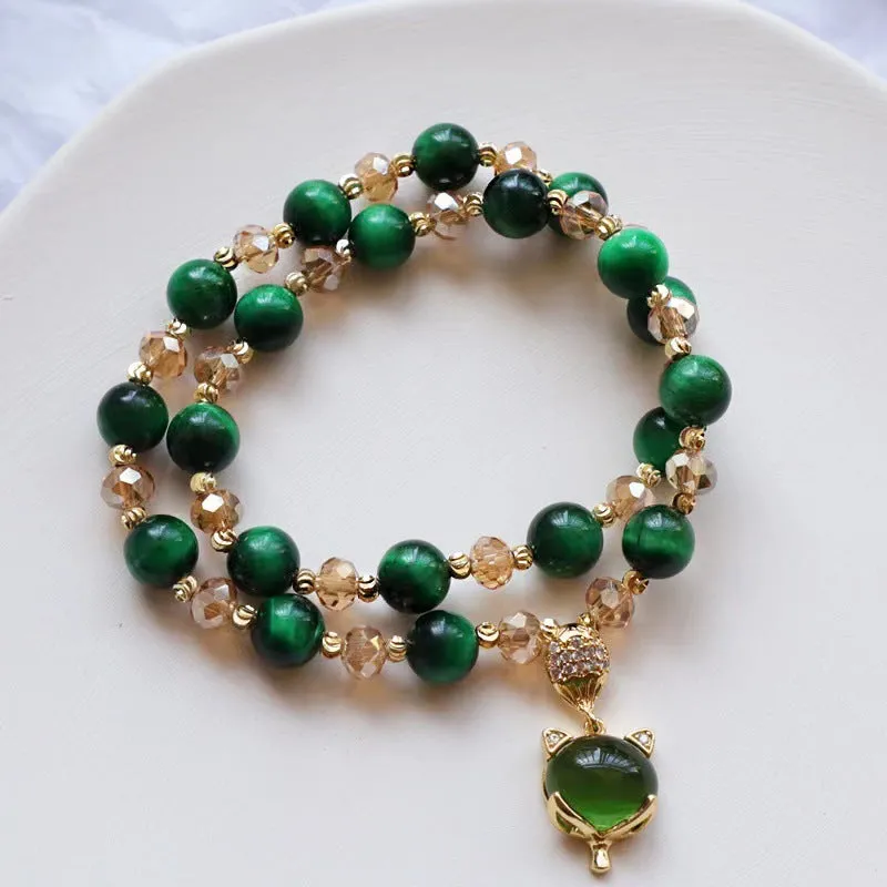 Handmade Tigereye stone bracelet on wrist, showing single chain and rose red fox charm.