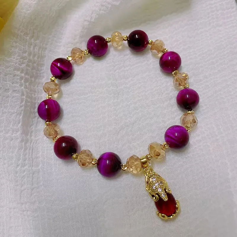 Handmade Tigereye stone bracelet on wrist, showing single chain and rose red fox charm.