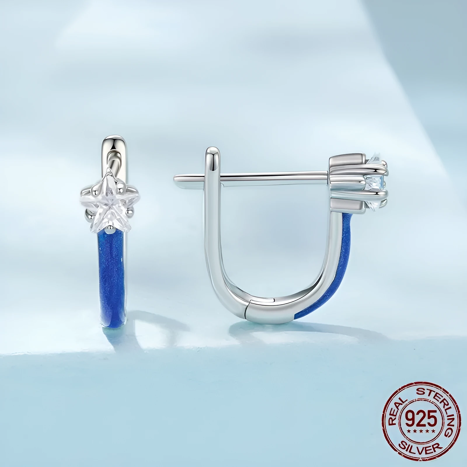 Pair of 925 sterling silver blue star pentagram ear clips with drip oil finish on white background