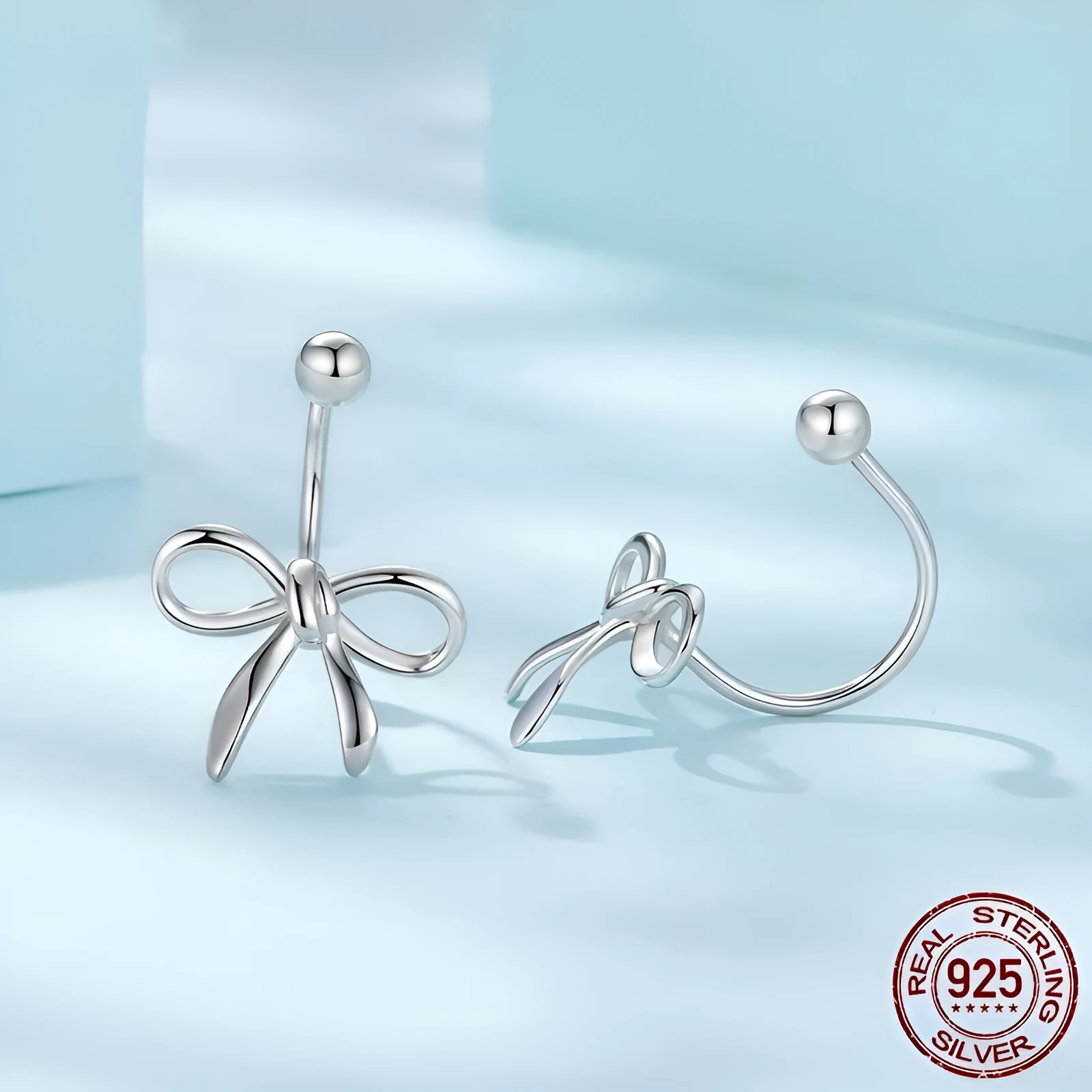 Women's S925 sterling silver bow stud earrings, polished silver finish, 1.2 cm bow shape on white background