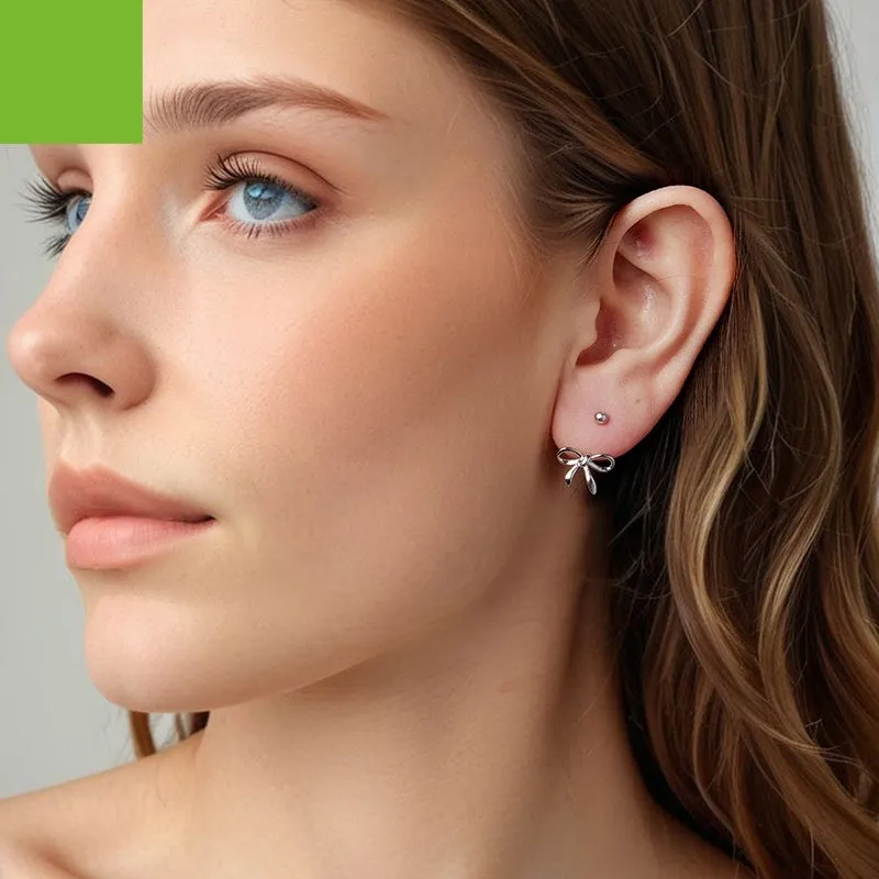 Women's S925 sterling silver bow stud earrings, polished silver finish, 1.2 cm bow shape on white background