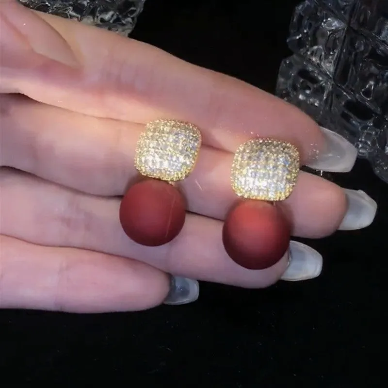 Micro inlaid zircon square pearl stud earrings with tassel detail in copper and imitation pearl, available in three colours: champagne, red, white.