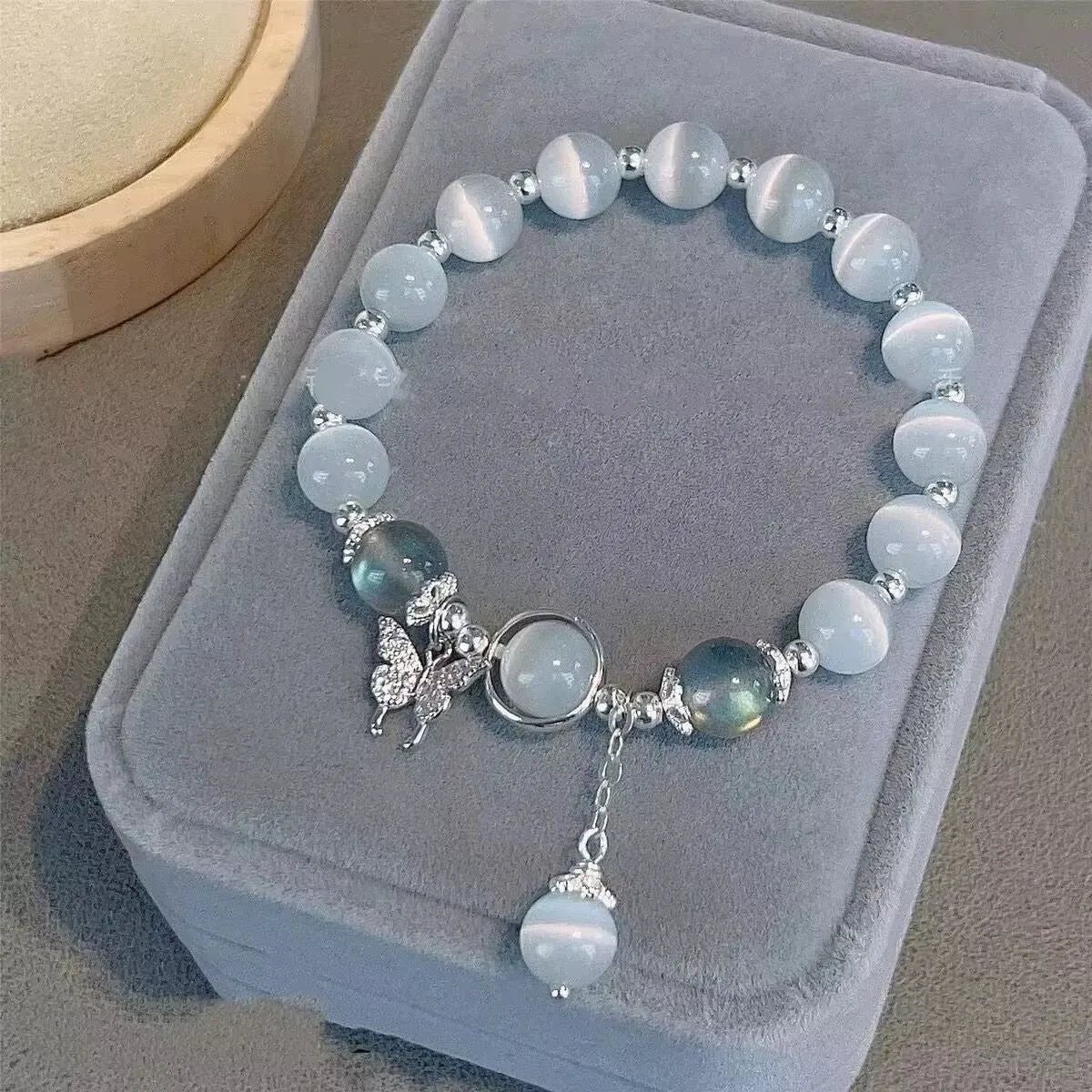 Glass butterfly bracelet for women with drop-shaped coloured glaze beads in grey moonlight colour option