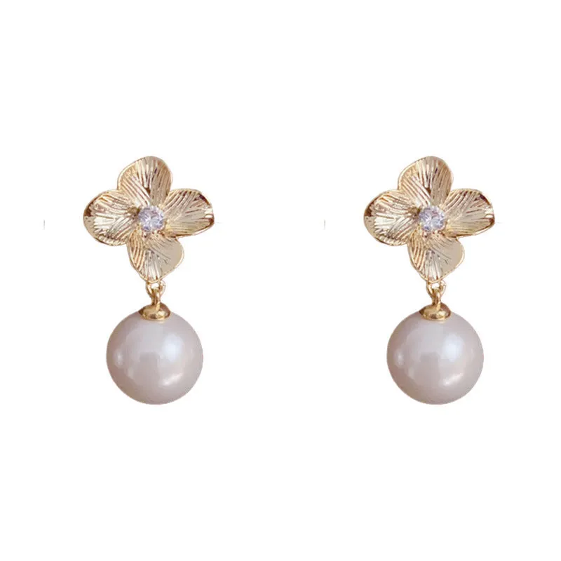 Pair of gold-plated copper earrings with metal petal design and faux pearl accents for women