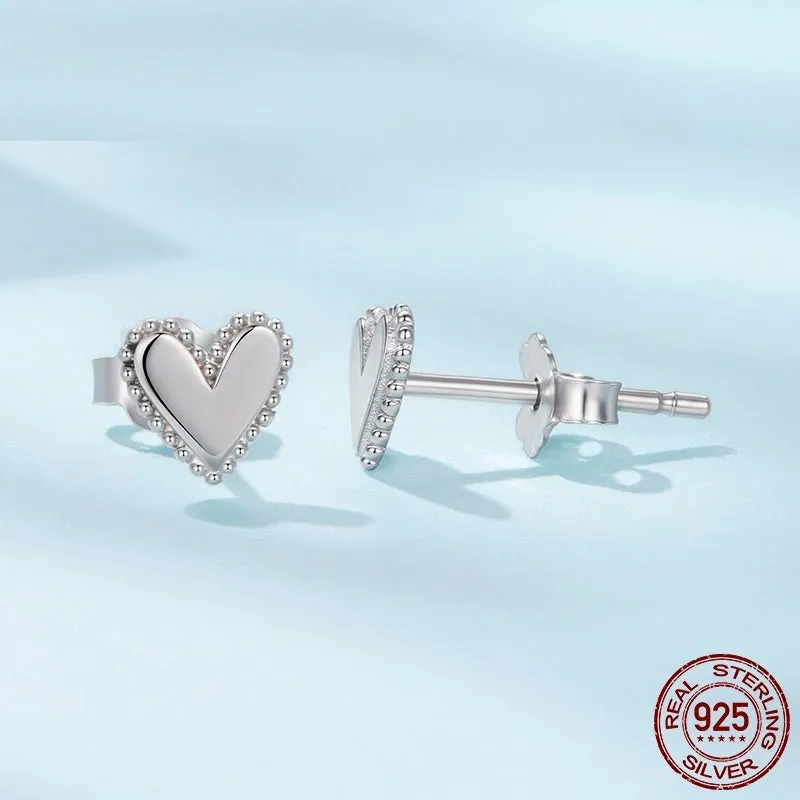 Simple S925 sterling silver heart-shaped ear studs with electroplated finish on a white background