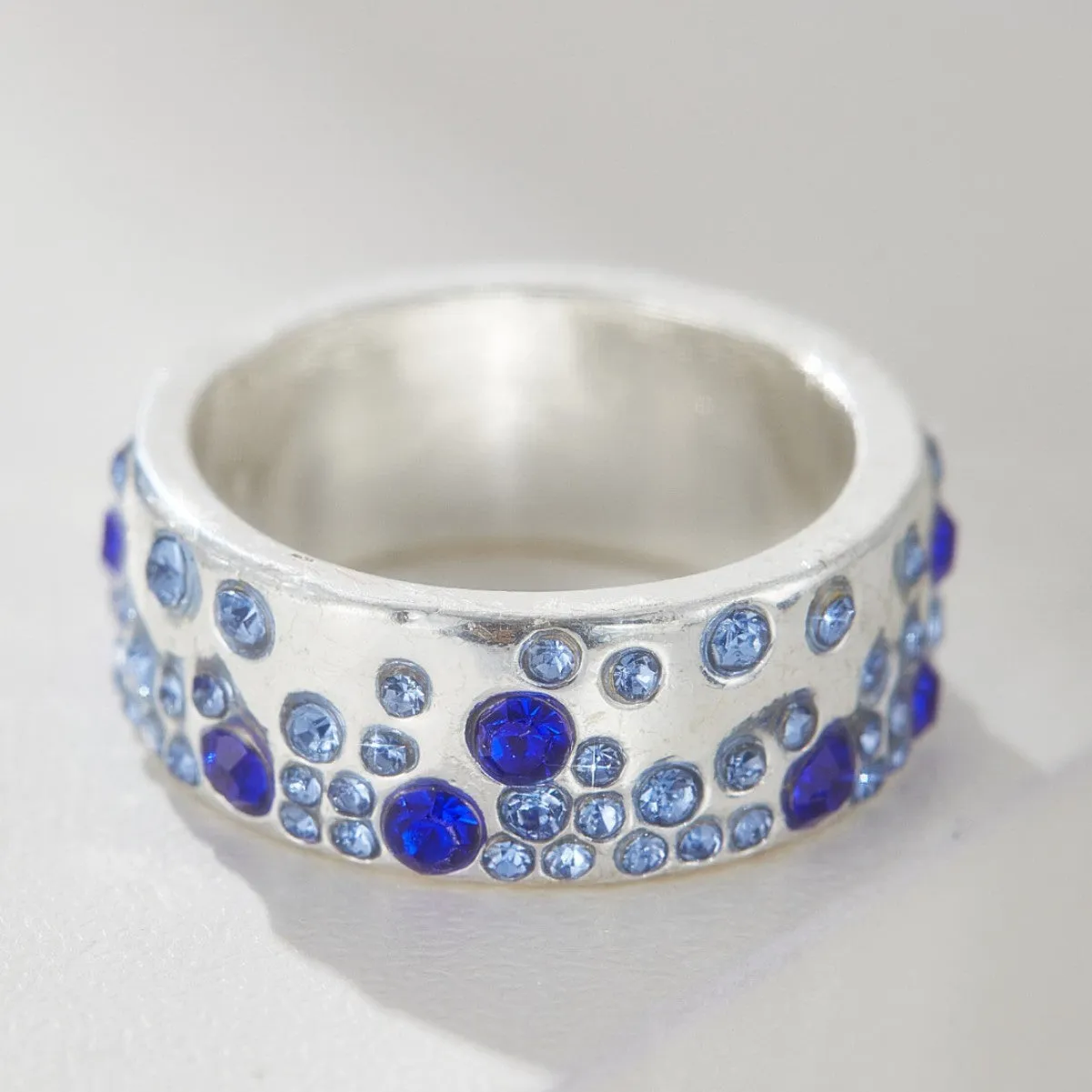 Mixed colour diamond retro personality ring in unisex geometric style on a white background.