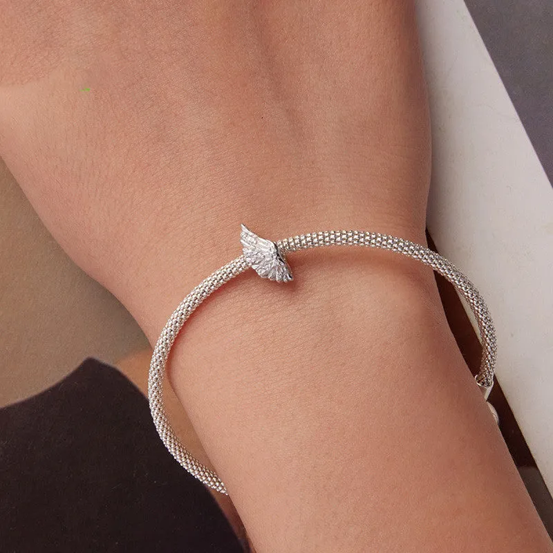 S925 sterling silver wing bead inlaid with zircon on a white background showing 1.4cm size