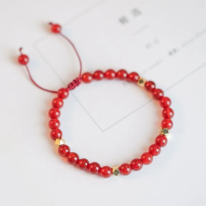 Hand-woven natural red agate bracelet showing diamond-shaped beads in ethnic woven pattern