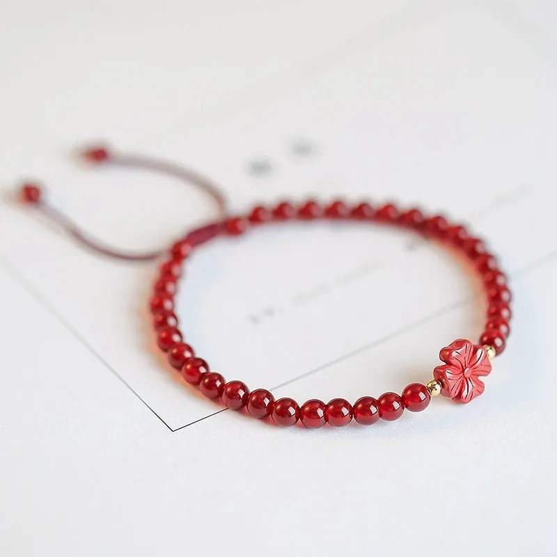 Hand-woven natural red agate bracelet showing diamond-shaped beads in ethnic woven pattern