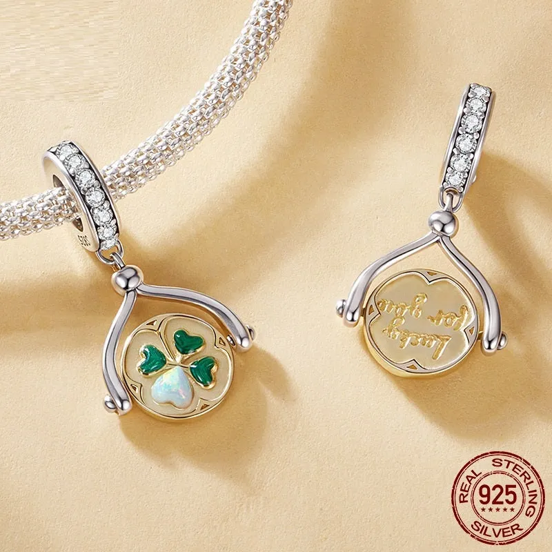 925 silver rotating card pendant with four-leaf clover pattern and wing element on white background