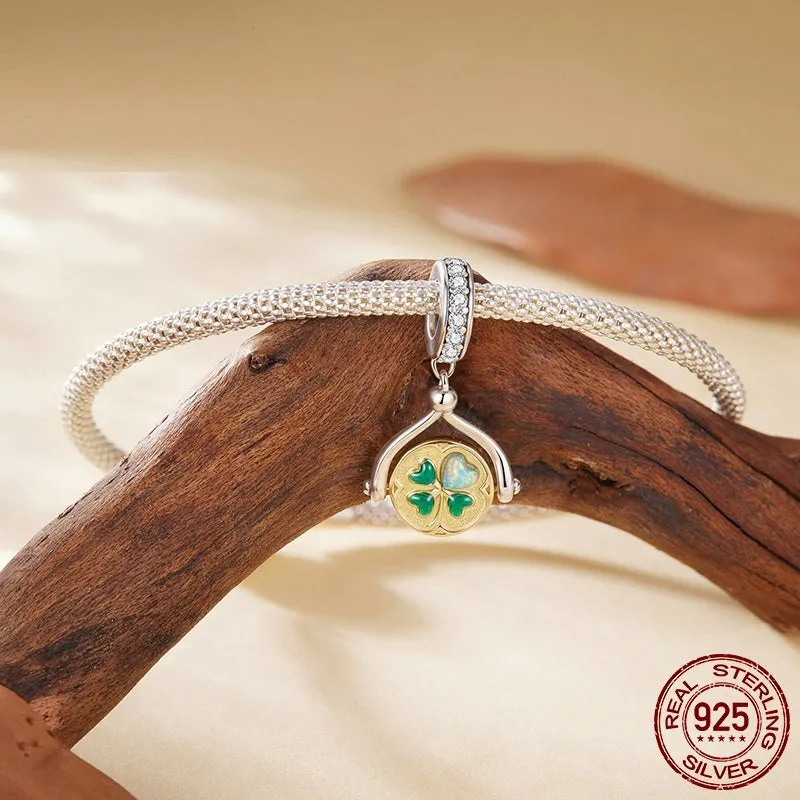925 silver rotating card pendant with four-leaf clover pattern and wing element on white background