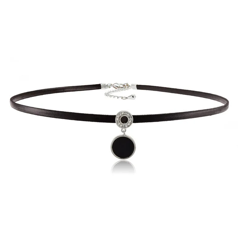 Women's short black clavicle necklace with round gold alloy pendant and leather rope chain on display