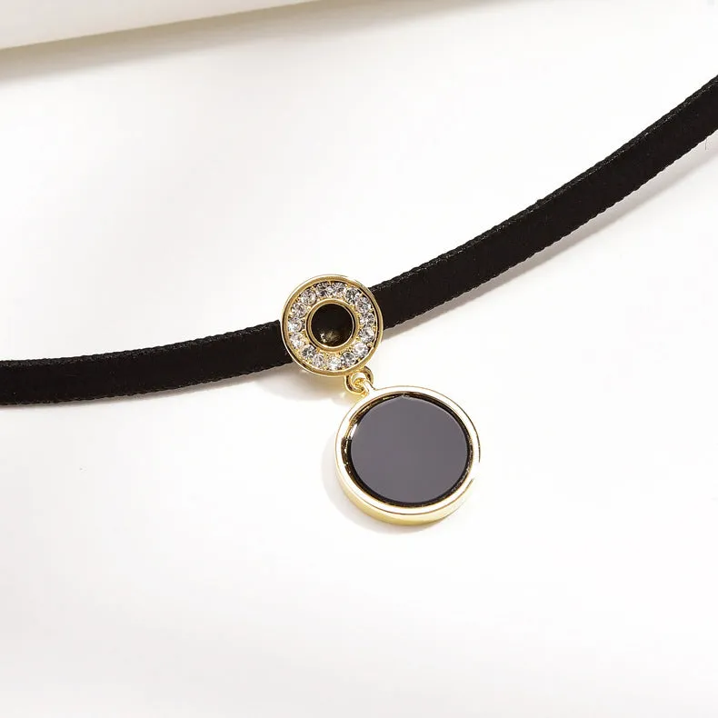 Women's short black clavicle necklace with round gold alloy pendant and leather rope chain on display
