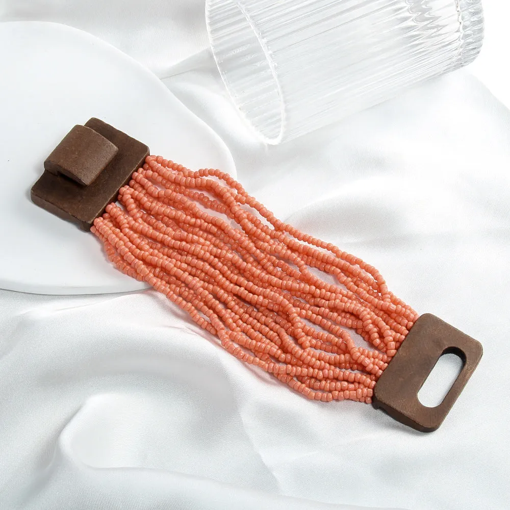 Handmade multi-layer elastic bracelet with rice-shaped glass and coloured glaze beads in geometric quadrilateral pattern, six colour options