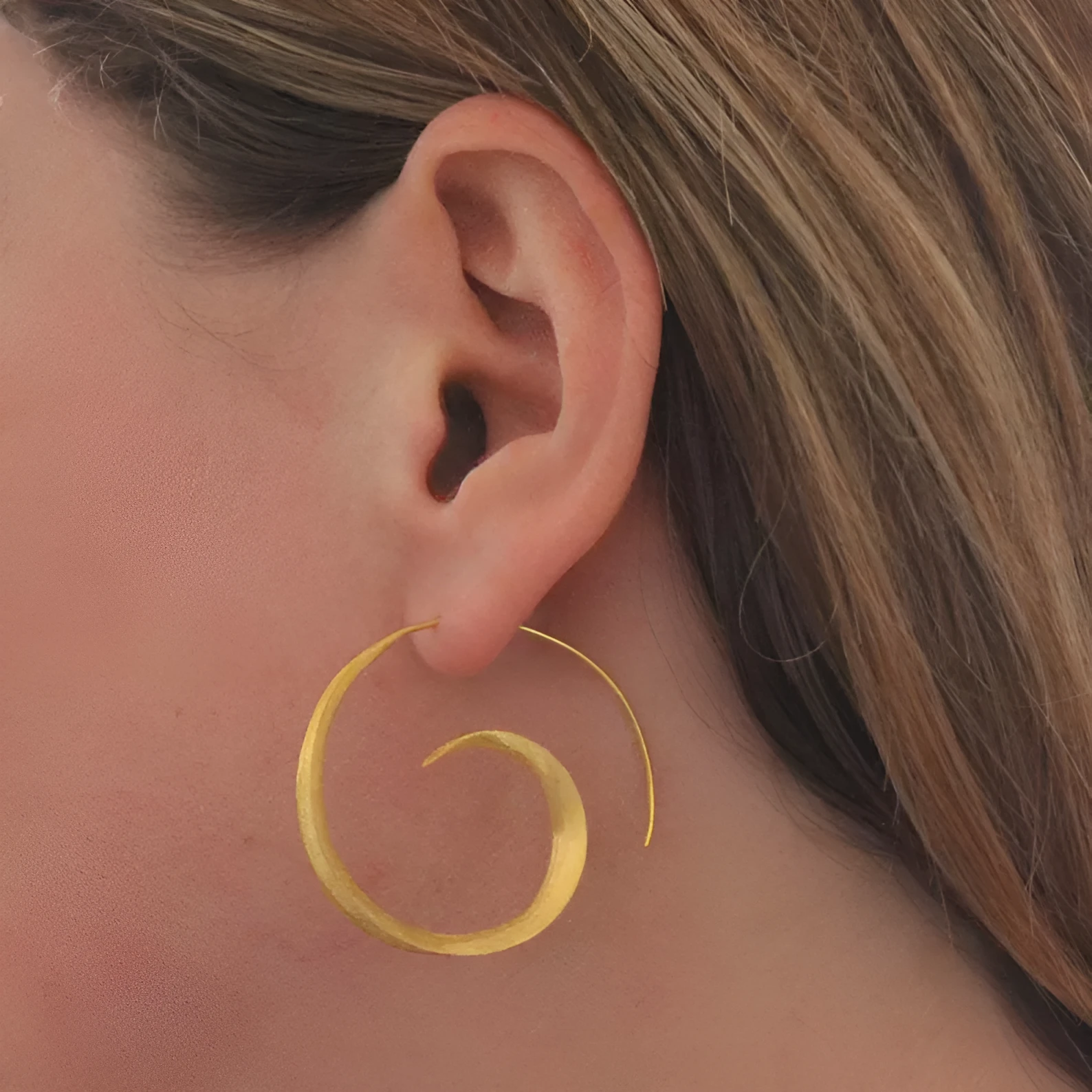 Round alloy ear studs with spiral leaf design in gold electroplated finish on white background