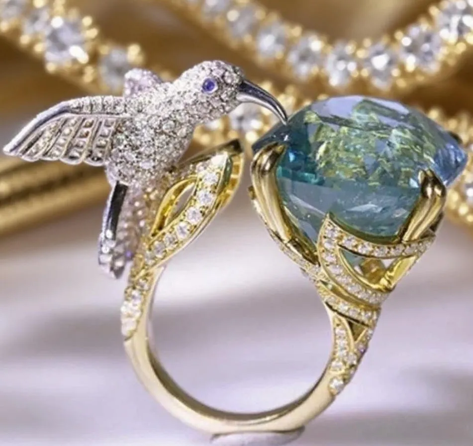 Ocean blue topaz hummingbird shape open ring with real gold colour brass finish and adjustable opening