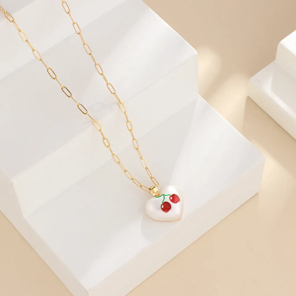 Heart-shaped necklace with geometric chain and a detailed fruit pendant charm, adjustable from 21cm to 50cm.