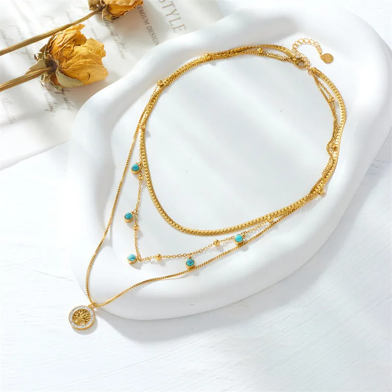 Gold-plated multi-layer stainless steel necklace with geometric tree pendant on woman