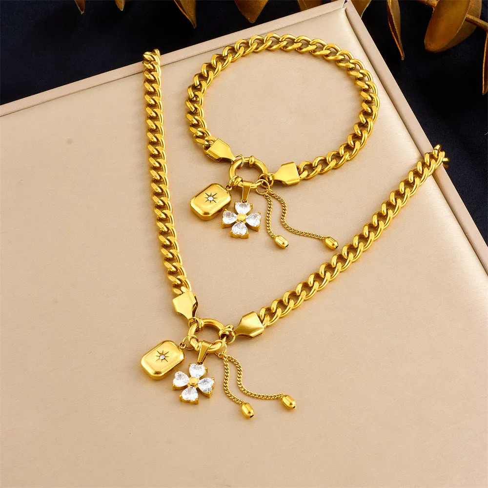 Tassel stainless steel bracelet and necklace set for women with flower and butterfly motifs on a white background