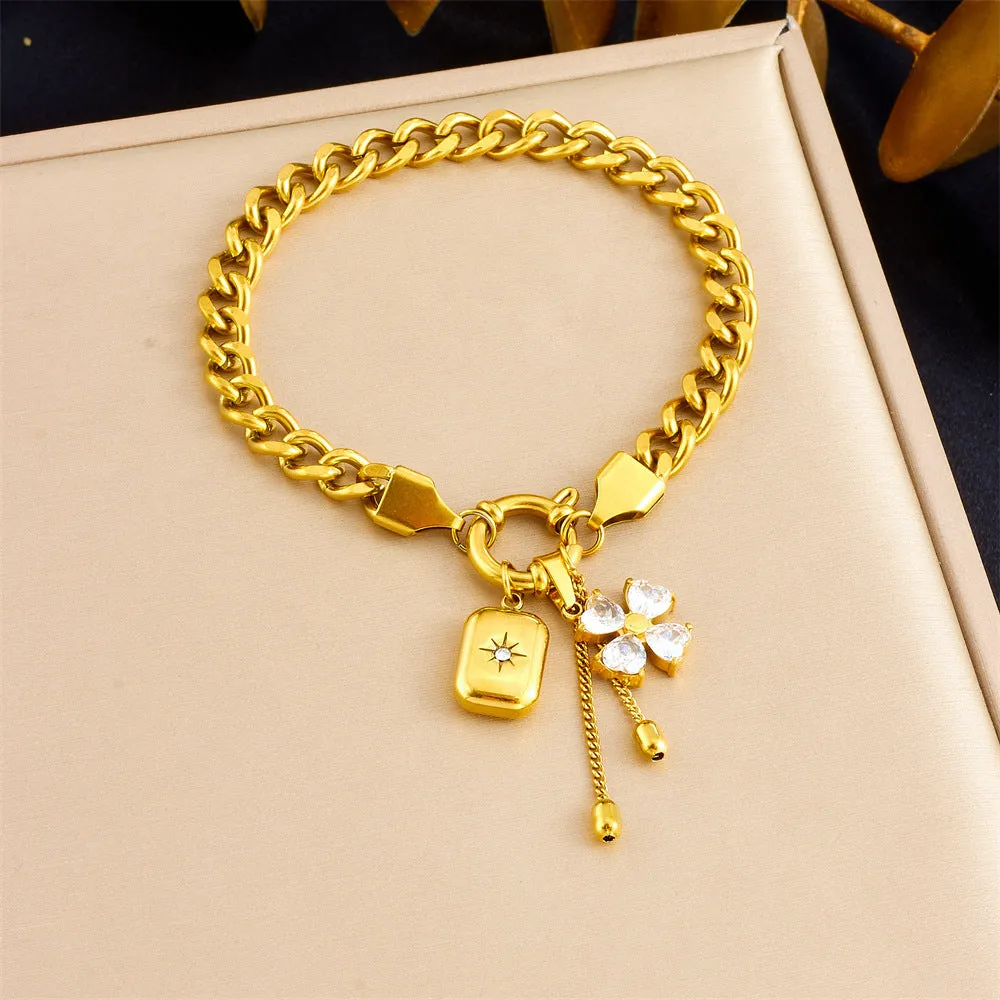 Tassel stainless steel bracelet and necklace set for women with flower and butterfly motifs on a white background