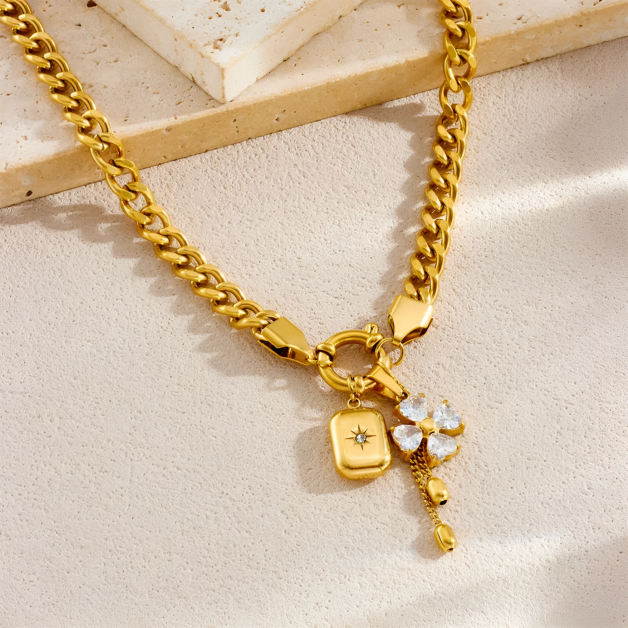 Tassel stainless steel bracelet and necklace set for women with flower and butterfly motifs on a white background