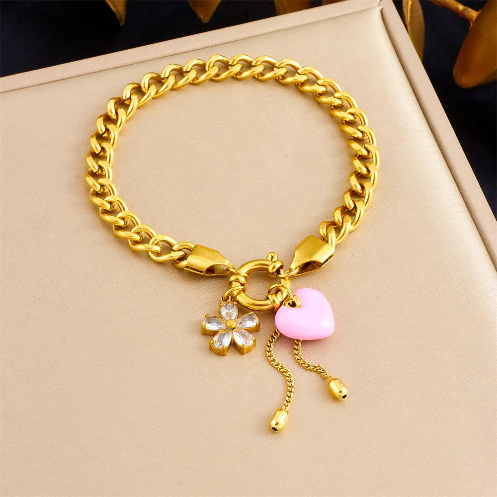 Tassel stainless steel bracelet and necklace set for women with flower and butterfly motifs on a white background