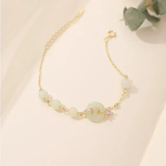 Sterling silver orchid necklace on a model, showing the floral pendant and peace buckle clasp.