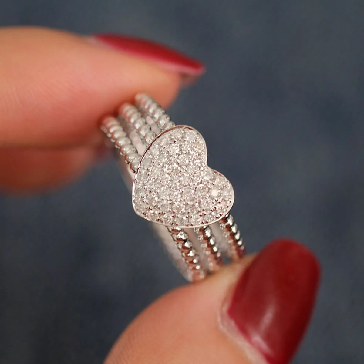 S925 sterling silver ring with heart twist design, available in white gold or yellow gold finish, US sizes 6 to 10