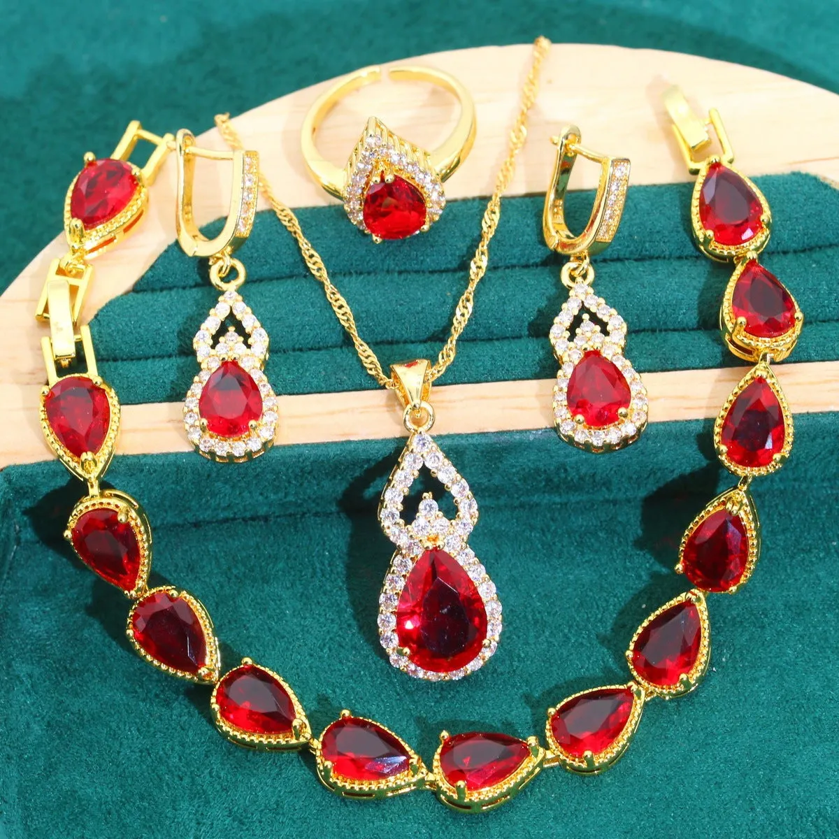 High-end bridal jewelry set with copper inlaid zircon cross and crown pendants in electroplated green and red finish on water wave chain