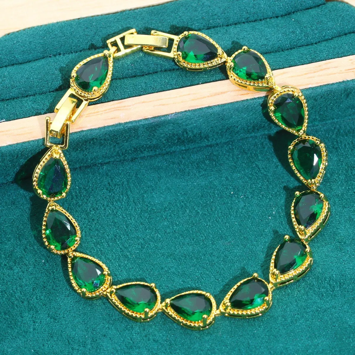 High-end bridal jewelry set with copper inlaid zircon cross and crown pendants in electroplated green and red finish on water wave chain