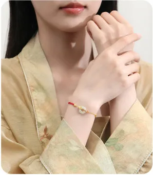 925 sterling silver red rope bracelet with a gold koi peace buckle safety clasp.