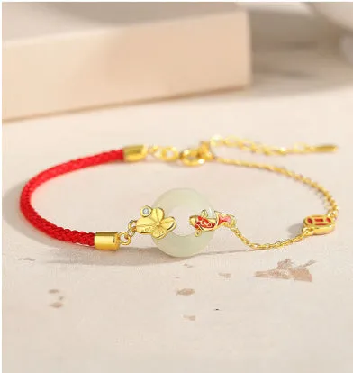 925 sterling silver red rope bracelet with a gold koi peace buckle safety clasp.