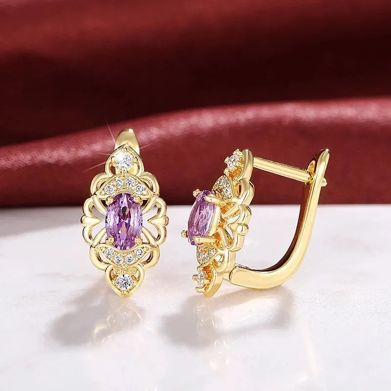 Pair of gold copper earrings with hollow flower design and zircon accents for women