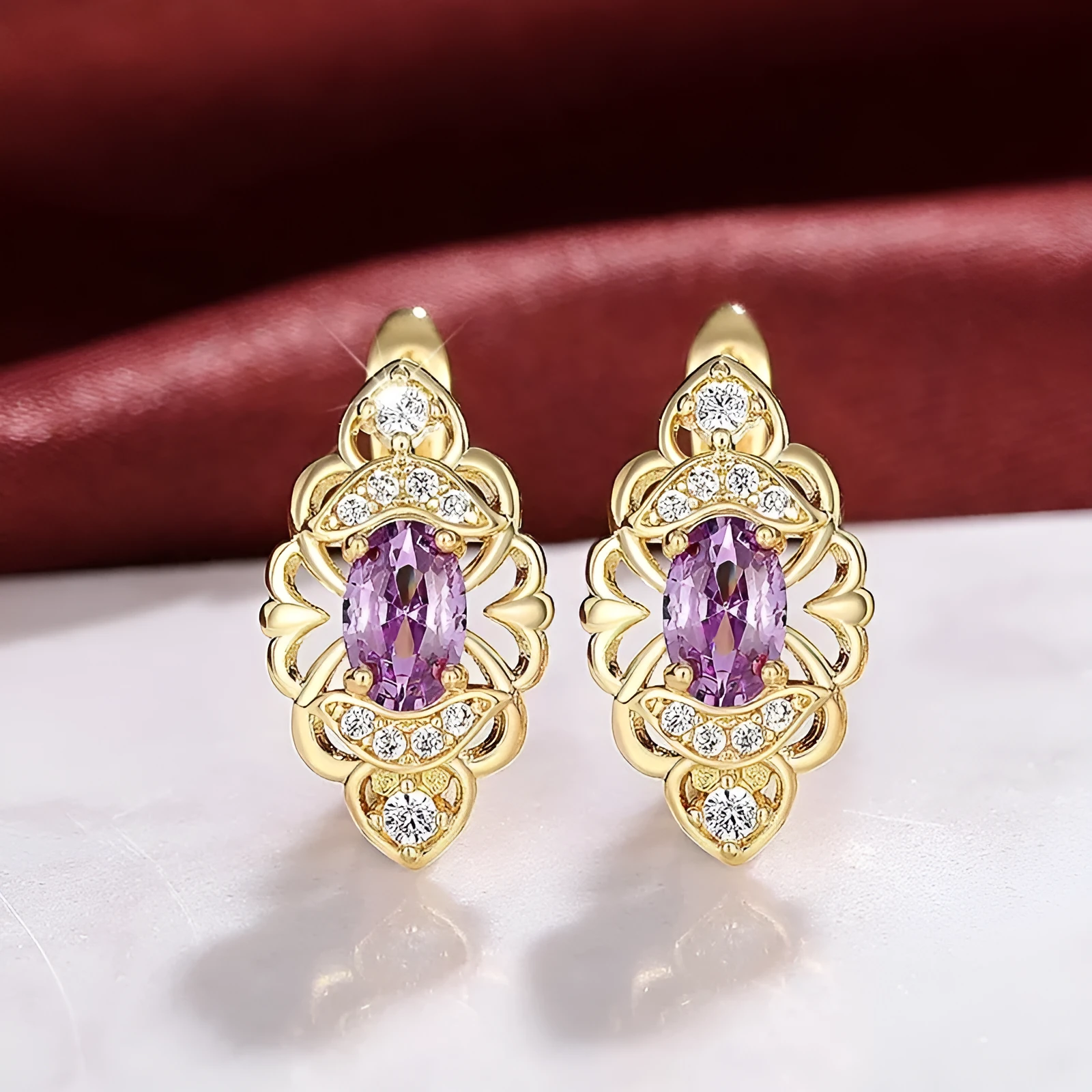 Pair of gold copper earrings with hollow flower design and zircon accents for women