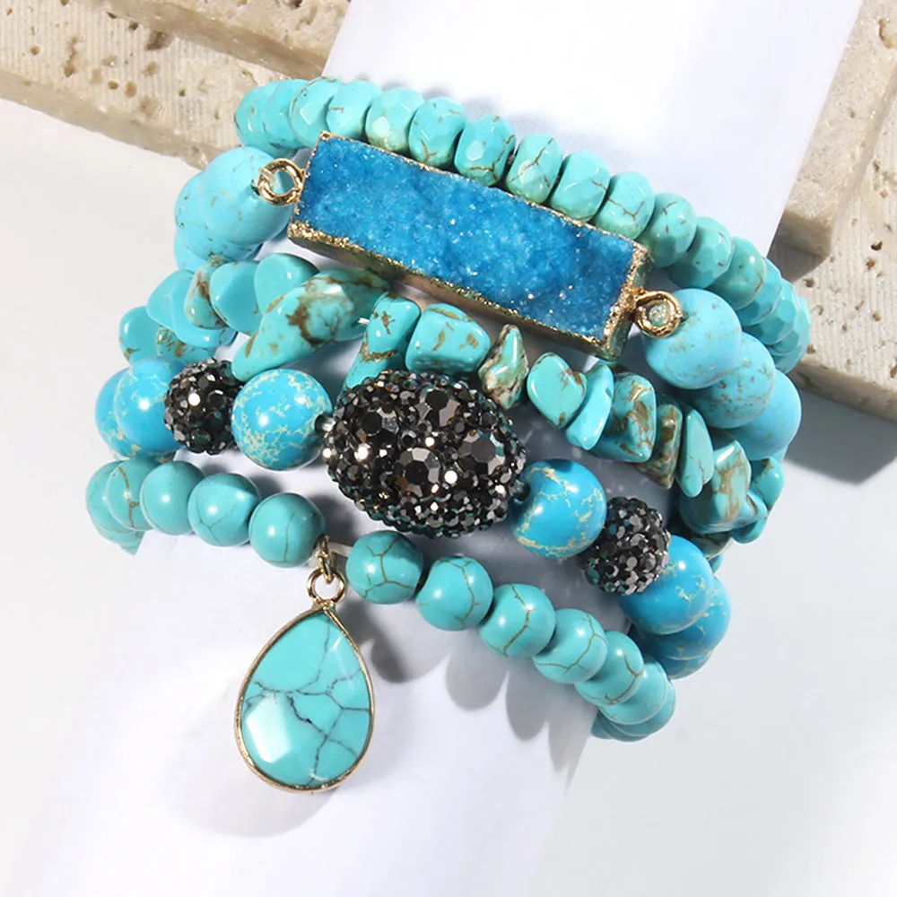 Set of five handmade stretch bracelets with glass, crystal, and hematite beads in irregular shapes on a neutral background