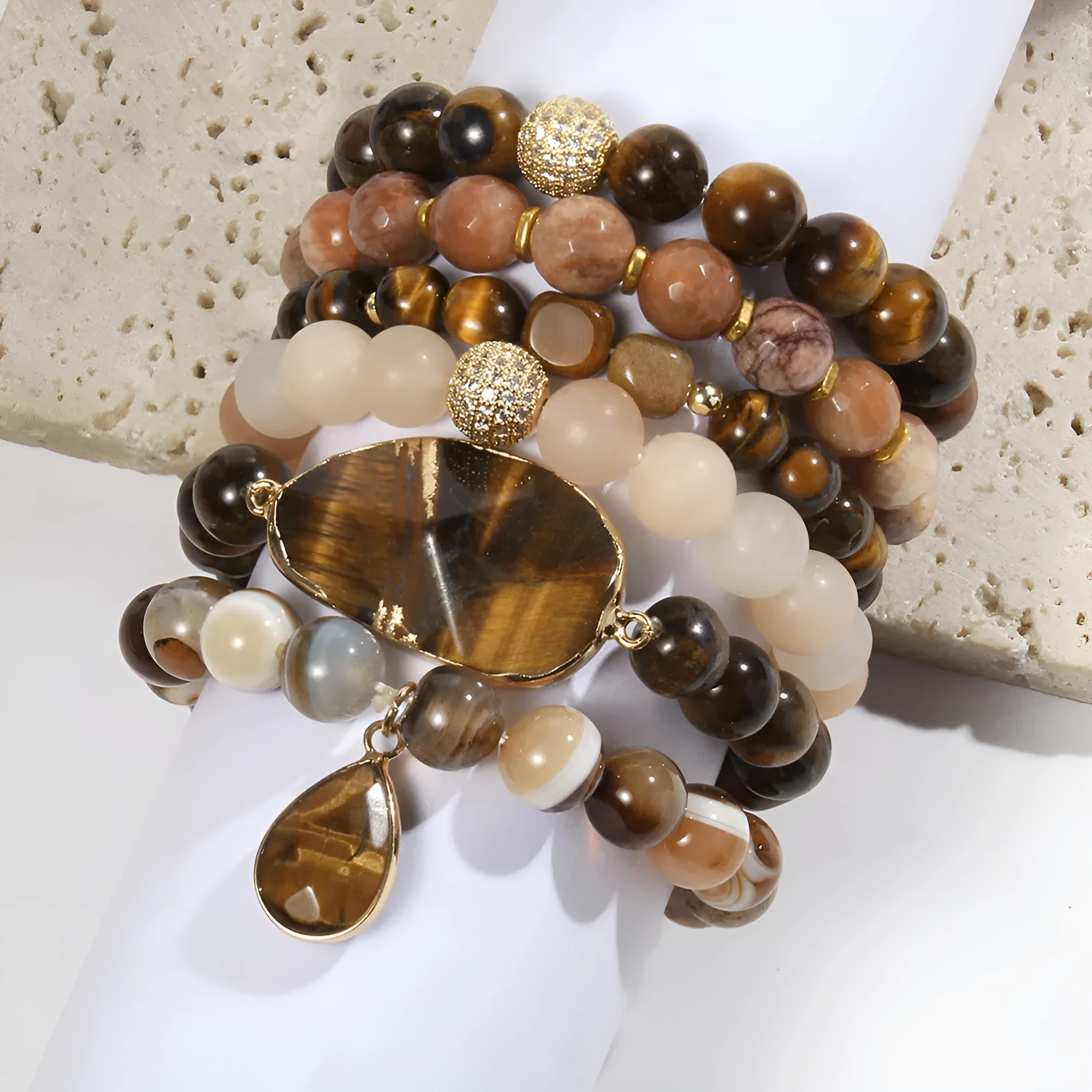 Women's glass beaded stretch bracelet set in brown with natural stone and zircon beads on a white surface