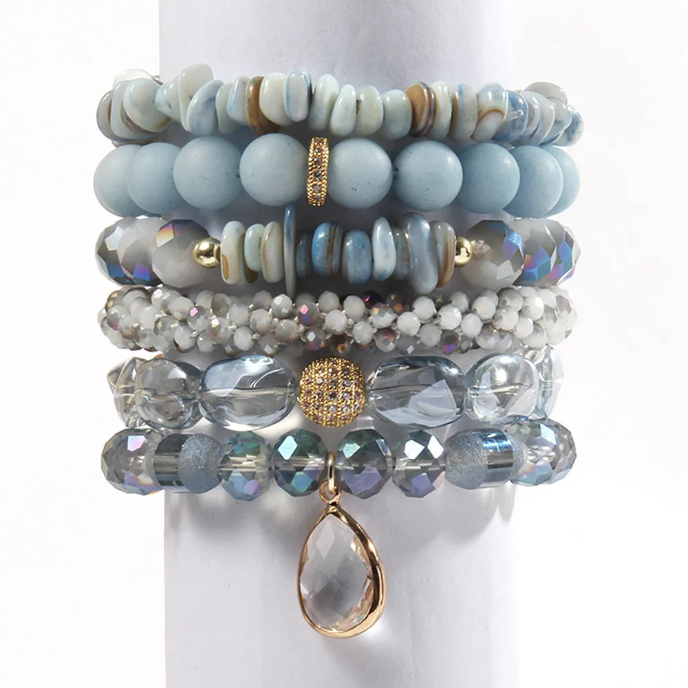 Women's glass beaded stretch bracelet set in brown with natural stone and zircon beads on a white surface