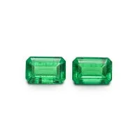 Cultivated emerald green treasure shaped colored gemstone round cut polished loose stone on white background