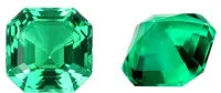 Cultivated emerald green treasure shaped colored gemstone round cut polished loose stone on white background